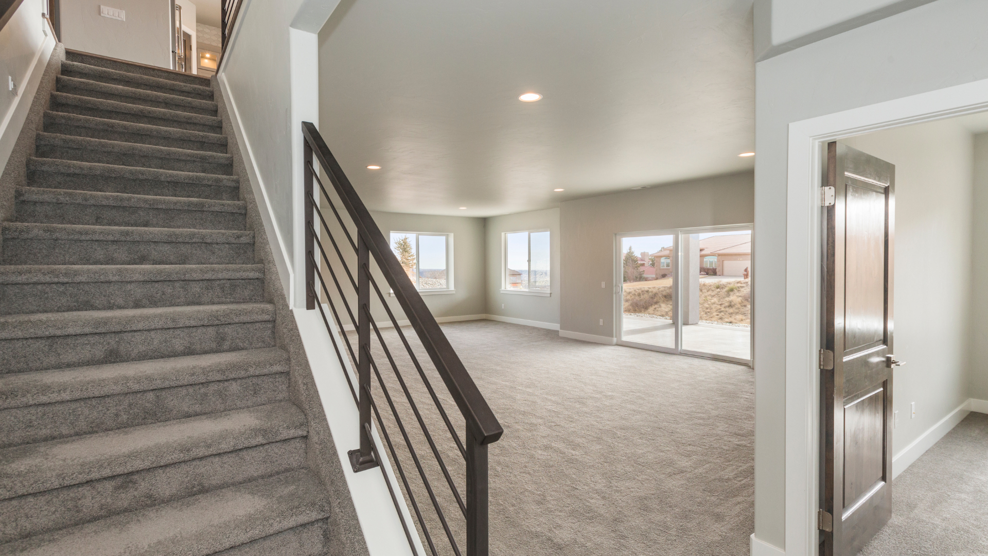 An empty basement under construction with wooden beams and a staircase.