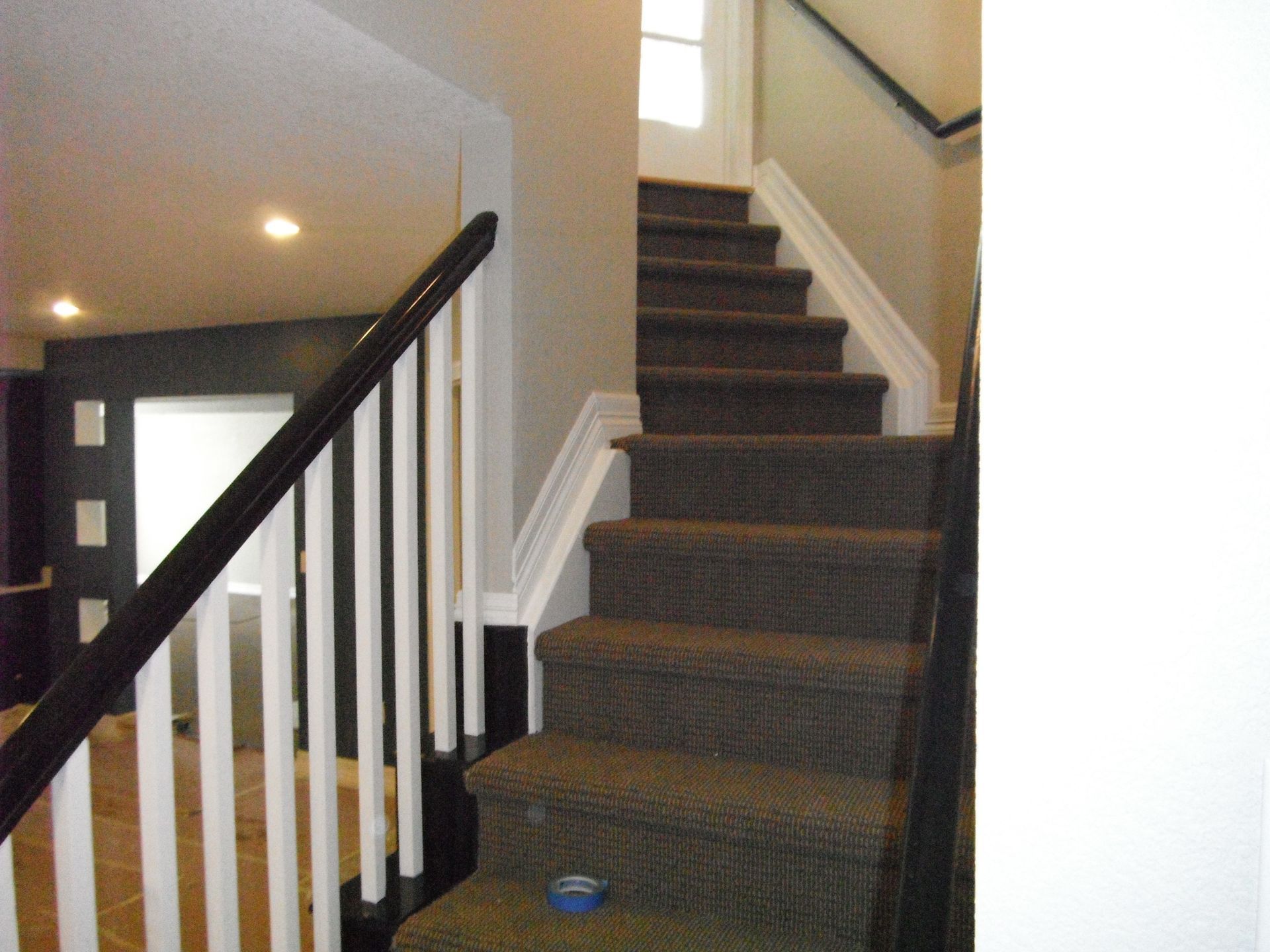 A staircase with carpeted steps and a white railing