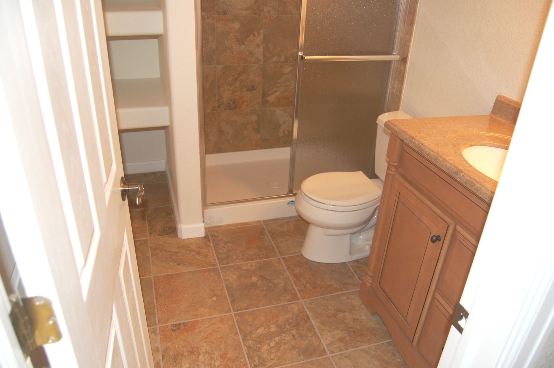 A bathroom with a toilet a sink and a shower