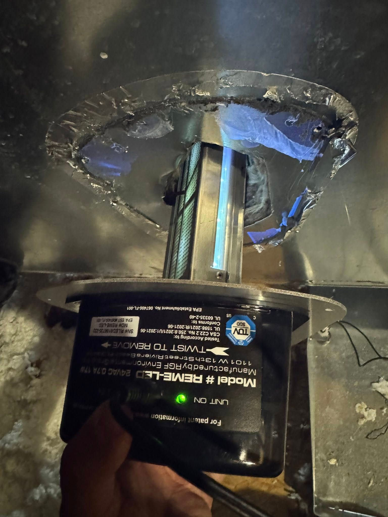 Skyline Comfort Services LLC - UV air purifier installed in ductwork; green light illuminated, showing it's on.