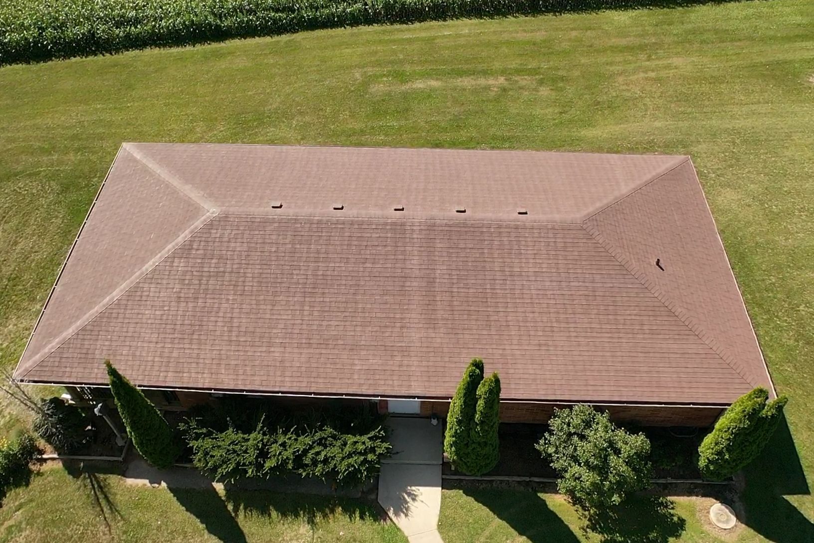 An aerial view of a house with a brown roof