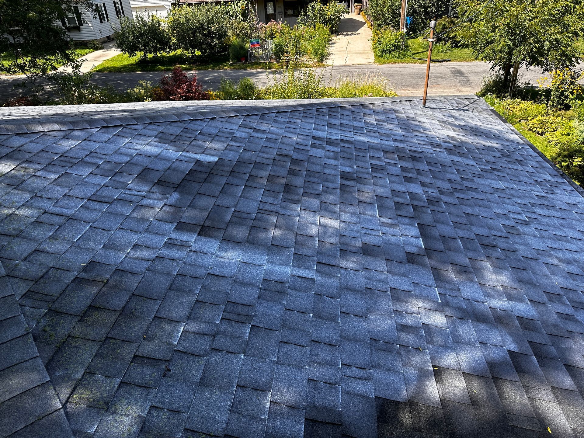 A close up of a roof with a lot of shingles on it.