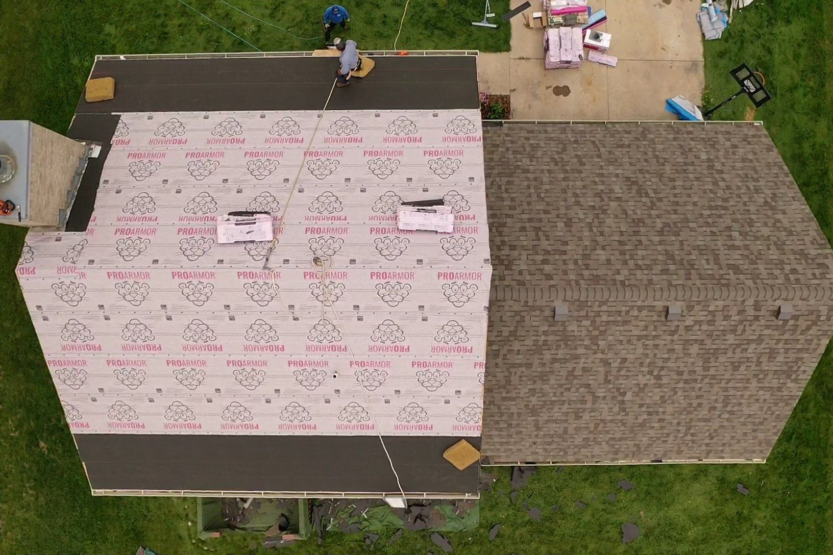 An aerial view of a house with a roof being installed