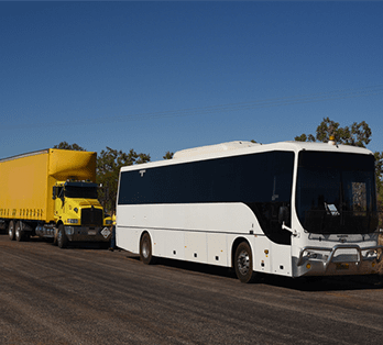 Yellow truck and white bus — Freight Services in Humpty Doo, NT