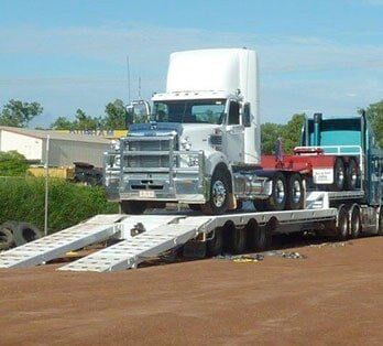 Truck carrying truck — Freight Services in Humpty Doo, NT