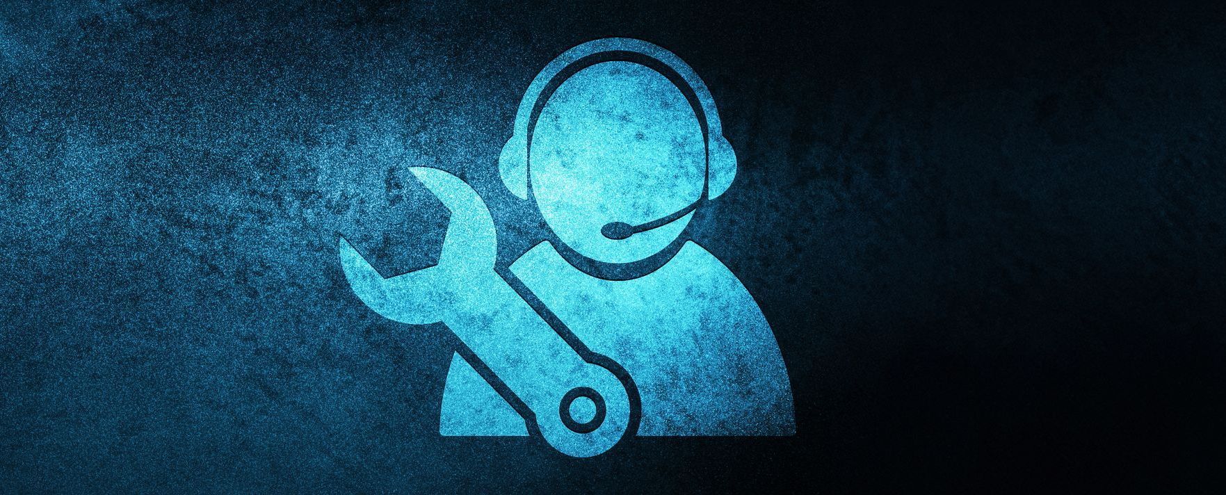 A man wearing headphones is holding a wrench.