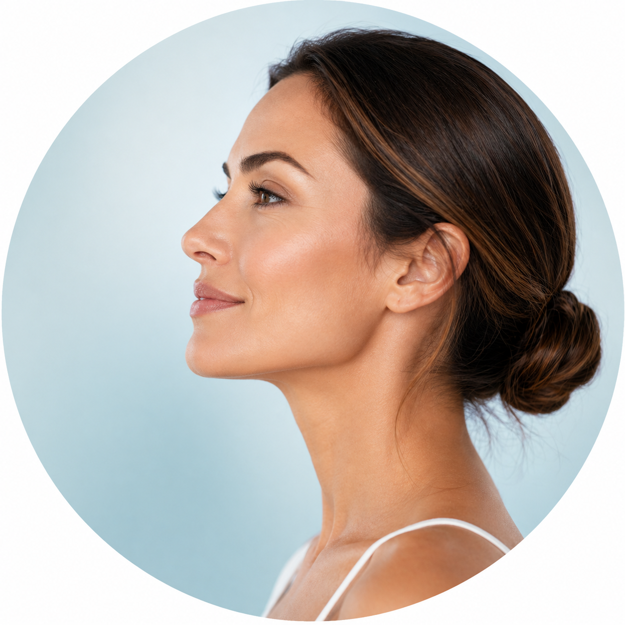 Side profile of a woman with a defined jawline and lifted cheeks, representing facial structural rejuvenation with Radiesse at Dr. Bass's clinic