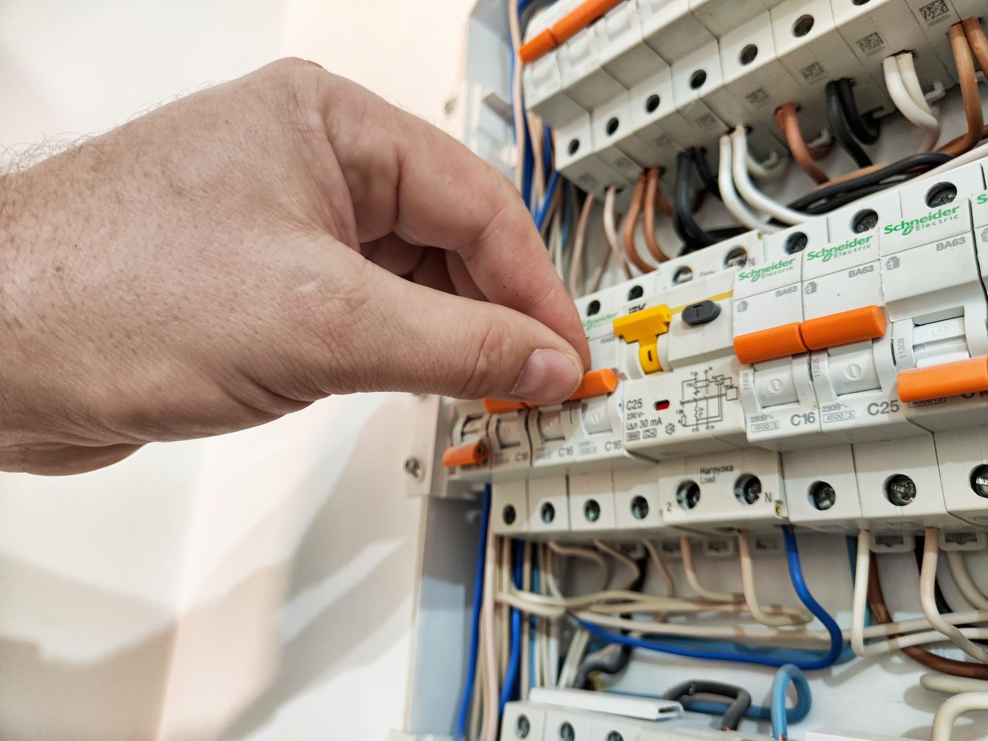 Hand flipping a breaker switch.