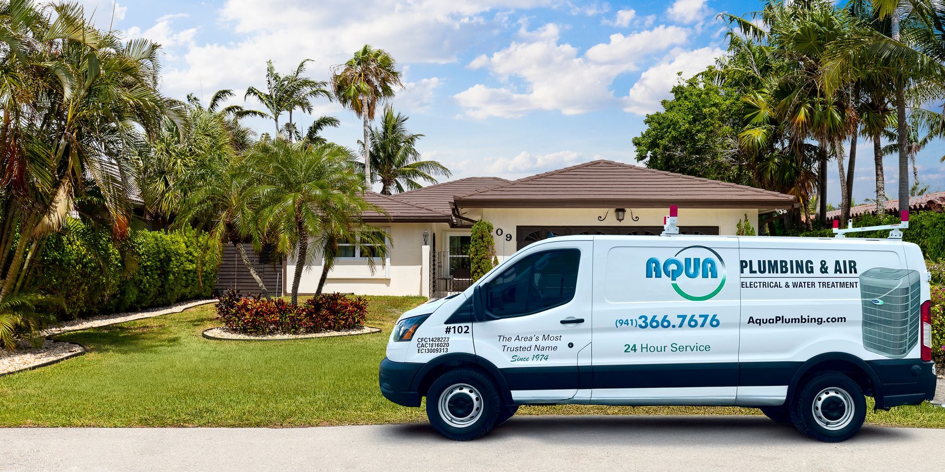 White plumber van parked in front of a house. 