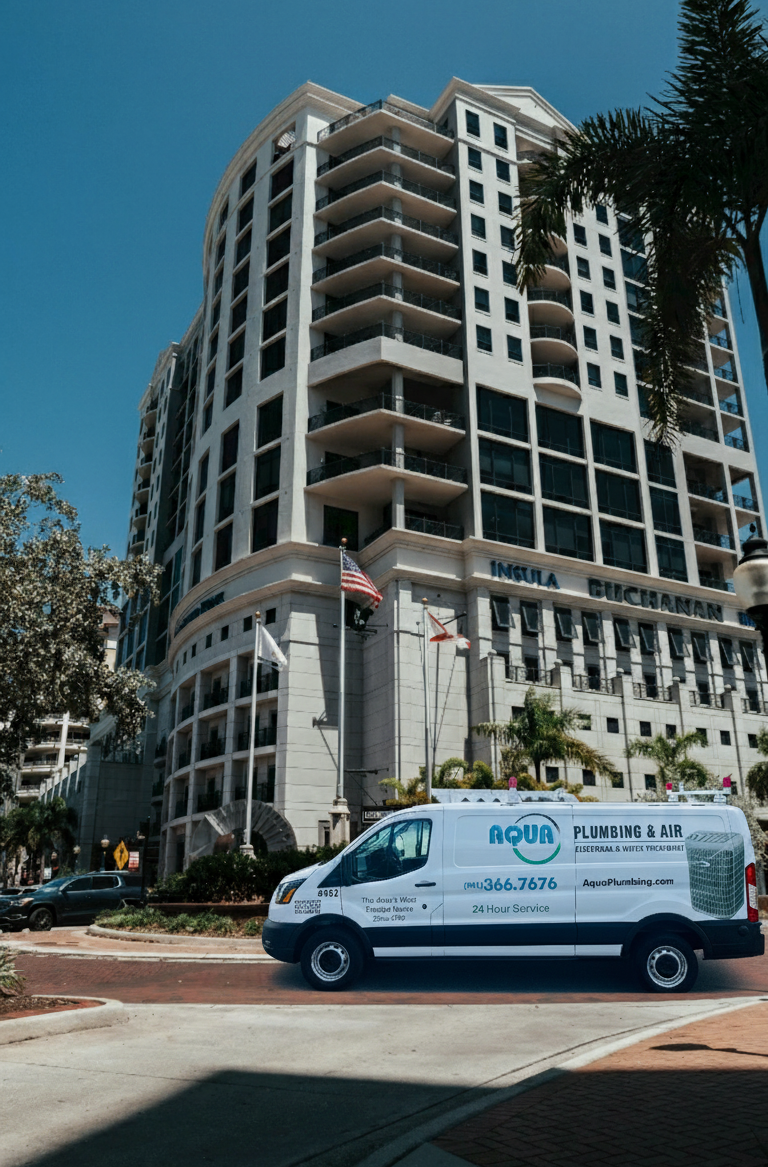 White van parked in front of a high-rise building with American and Florida flags.