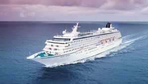 A large cruise ship is floating on top of a large body of water.