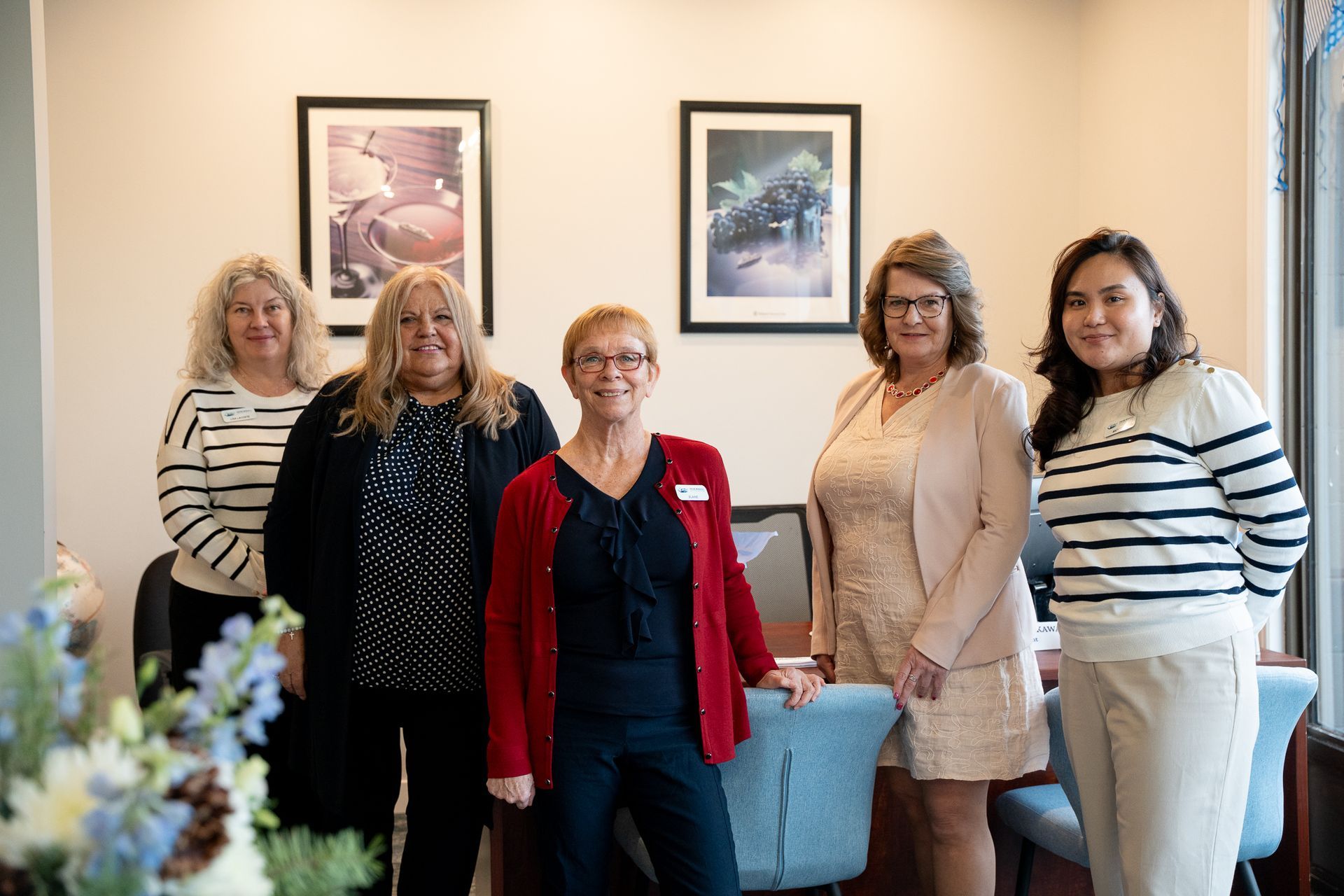 A group of women are posing for a picture in front of a cruise world sign.