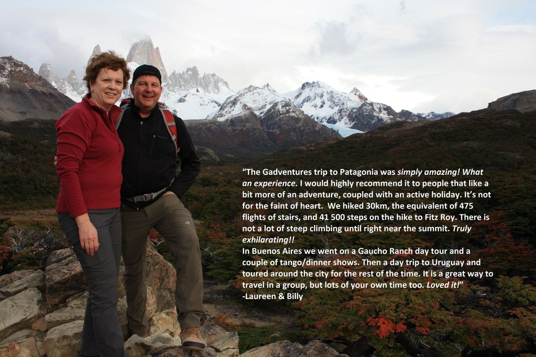 A man and a woman standing on top of a mountain