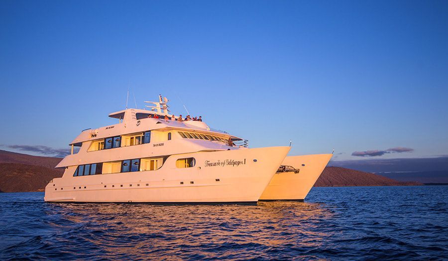 A large white yacht is floating on top of a body of water.