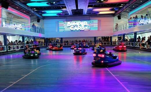 A group of people are riding bumper cars in an amusement park.