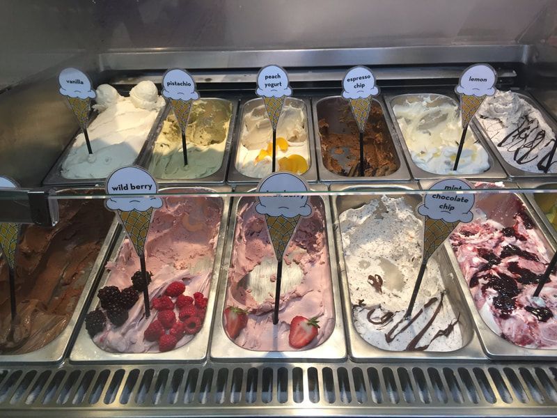 A display case filled with many different flavors of ice cream