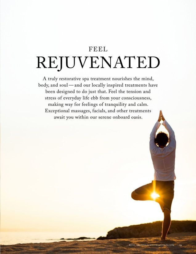 A man is standing in a yoga pose on the beach.