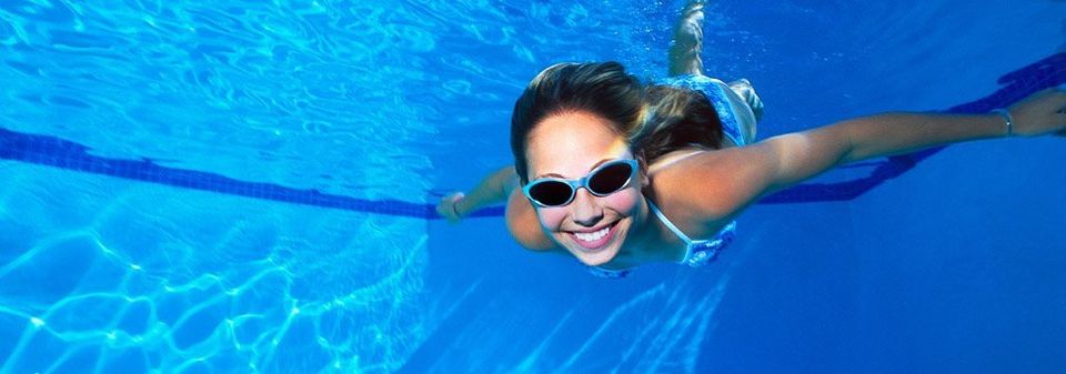 Women swimming underwater in a heated swimming pool