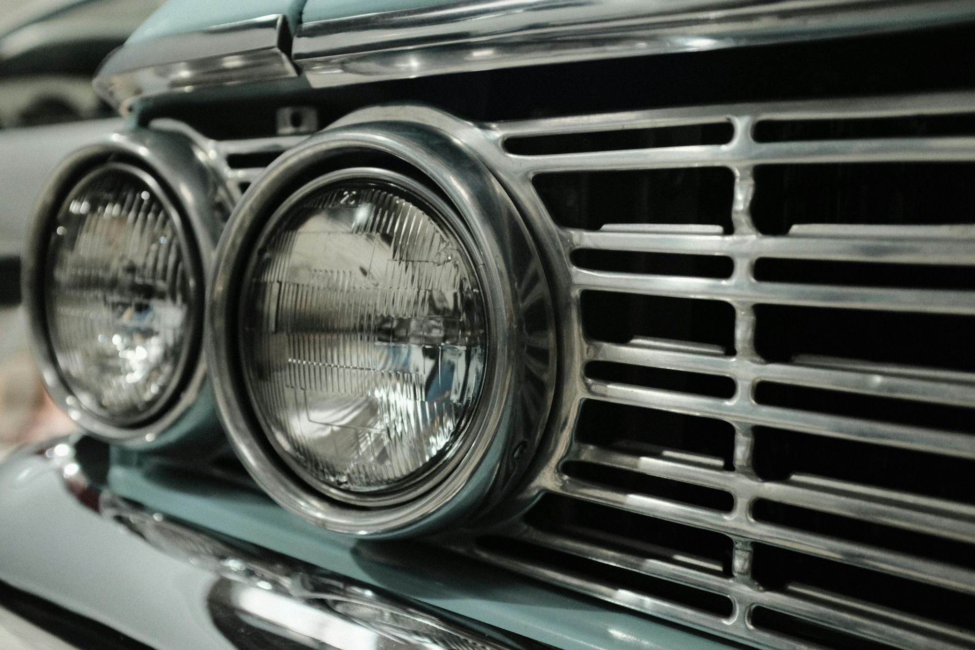 A close up of a car 's headlights and grill