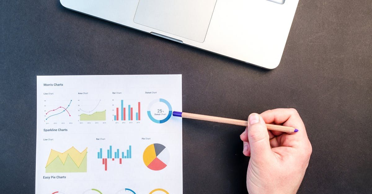 A person is pointing at a graph on a piece of paper with a pencil.
