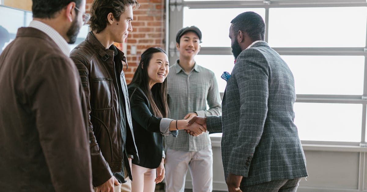 A group of people are shaking hands in a room.