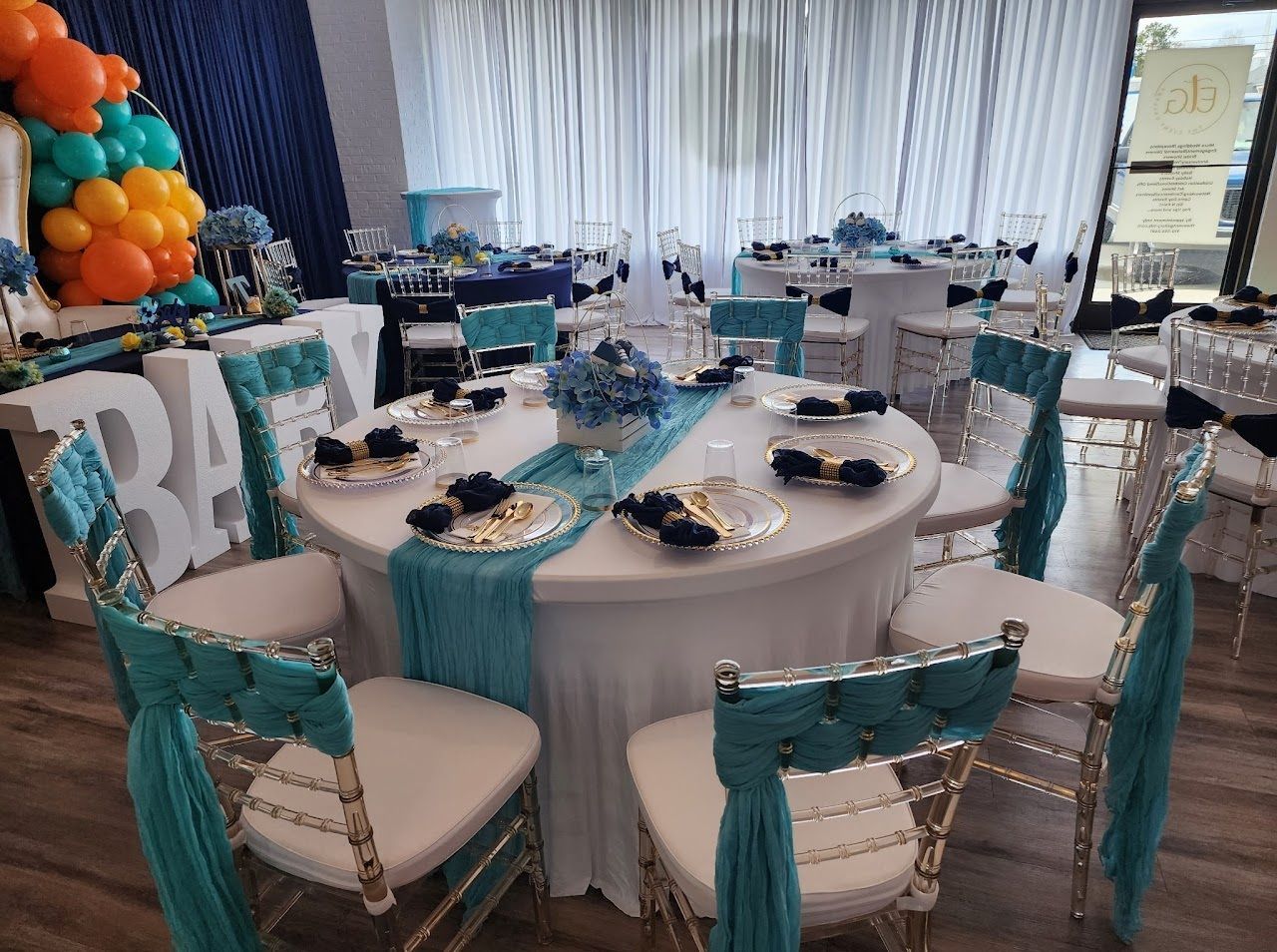 Party tables decorated with blue and teal accents.