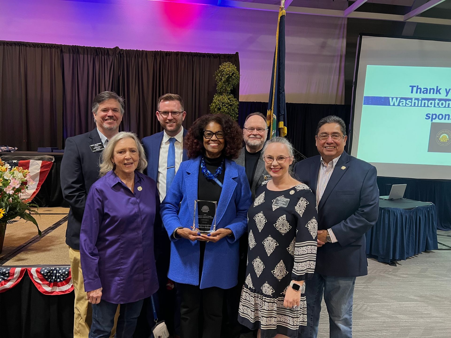 A group of people are posing for a picture in a room.