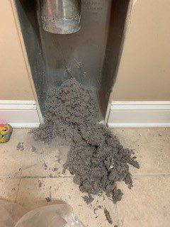 dryer vents dust in a pile on the floor 2