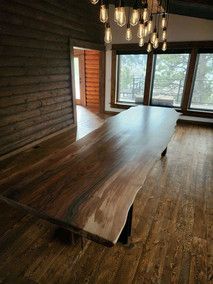 There is a long wooden table in the middle of the room.