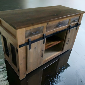 A wooden cabinet with sliding barn doors and drawers