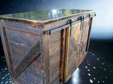 A wooden box with sliding barn doors on it