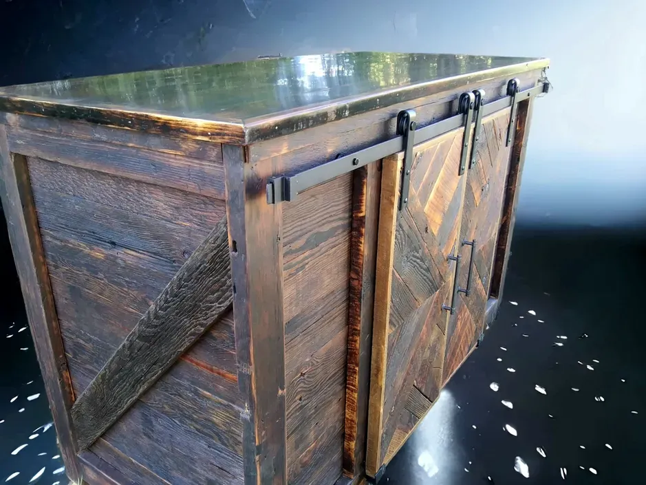 A wooden box with sliding barn doors on it