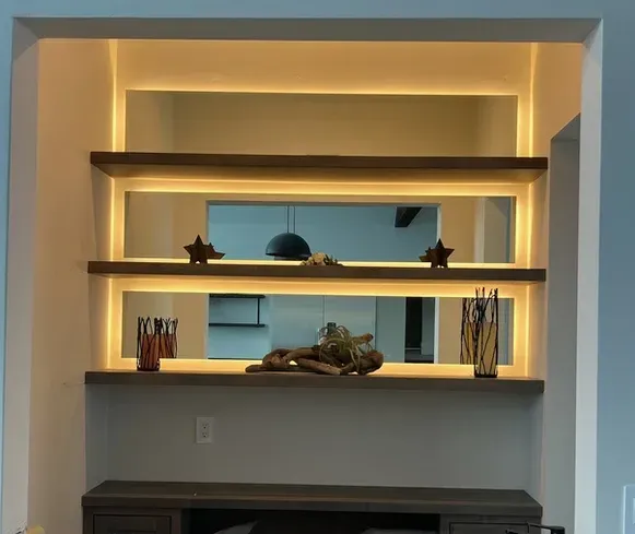 A shelf in a room with lights on it