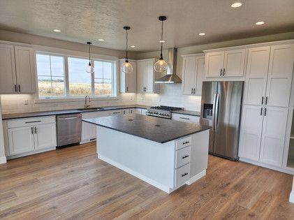 There is a large island in the middle of the kitchen.