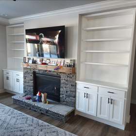 A living room with a fireplace and a flat screen tv