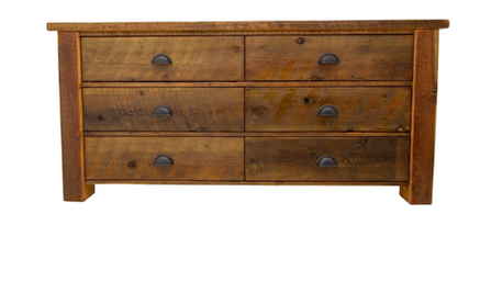 A wooden dresser with four drawers on a white background.