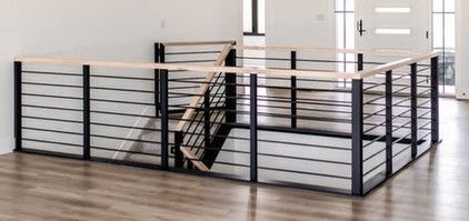 An empty room with a staircase and a railing.