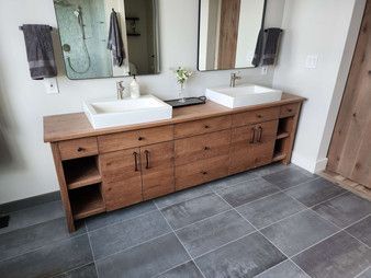 A bathroom with two sinks and two mirrors.