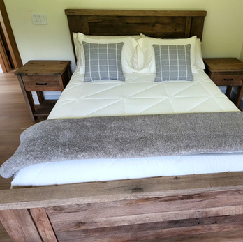 A bedroom with a bed and two nightstands