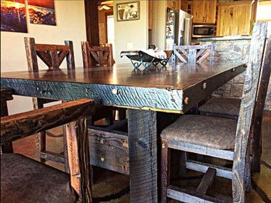 A wooden table and chairs in a dining room