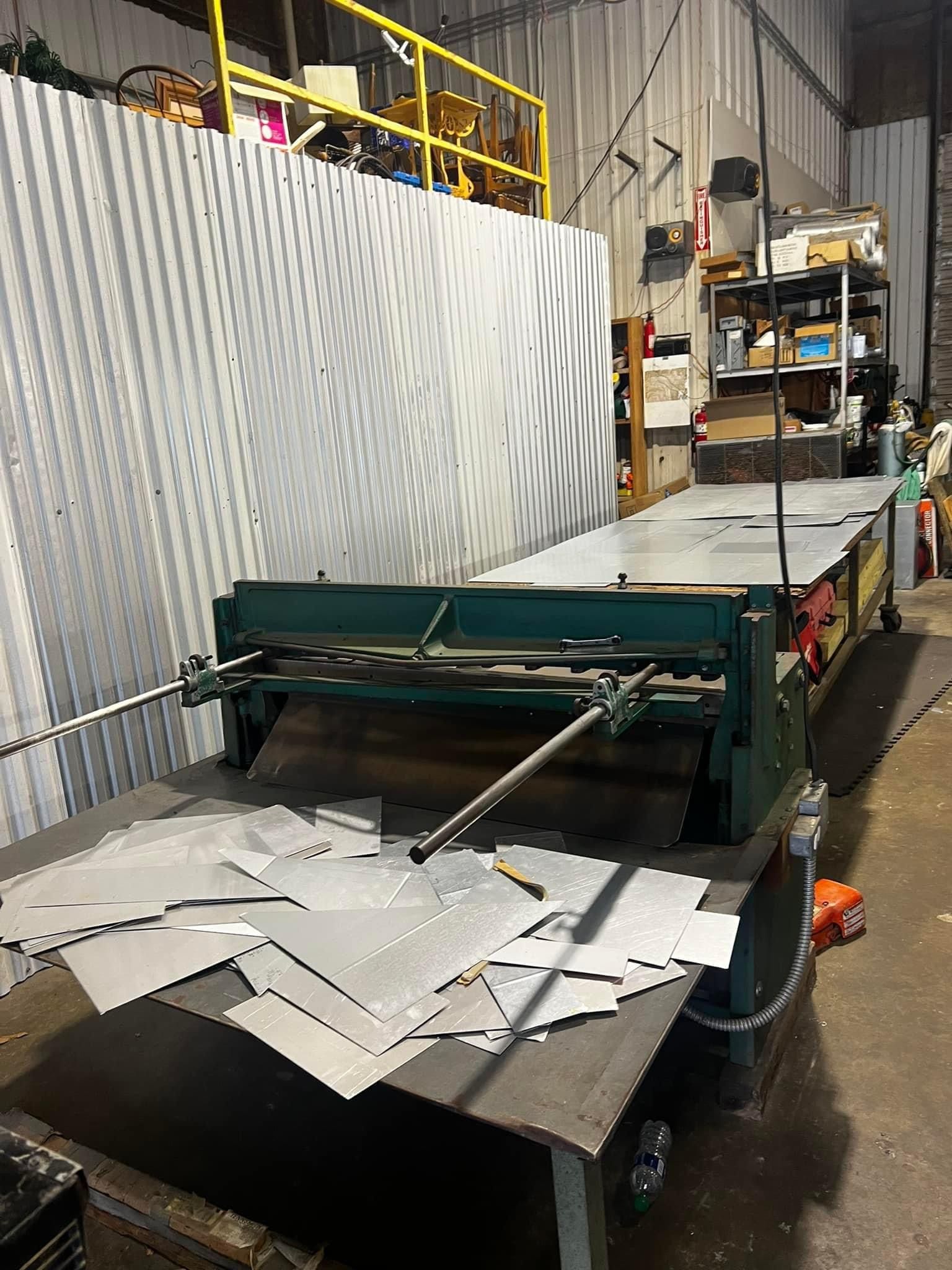 A machine is sitting on top of a table in a warehouse.