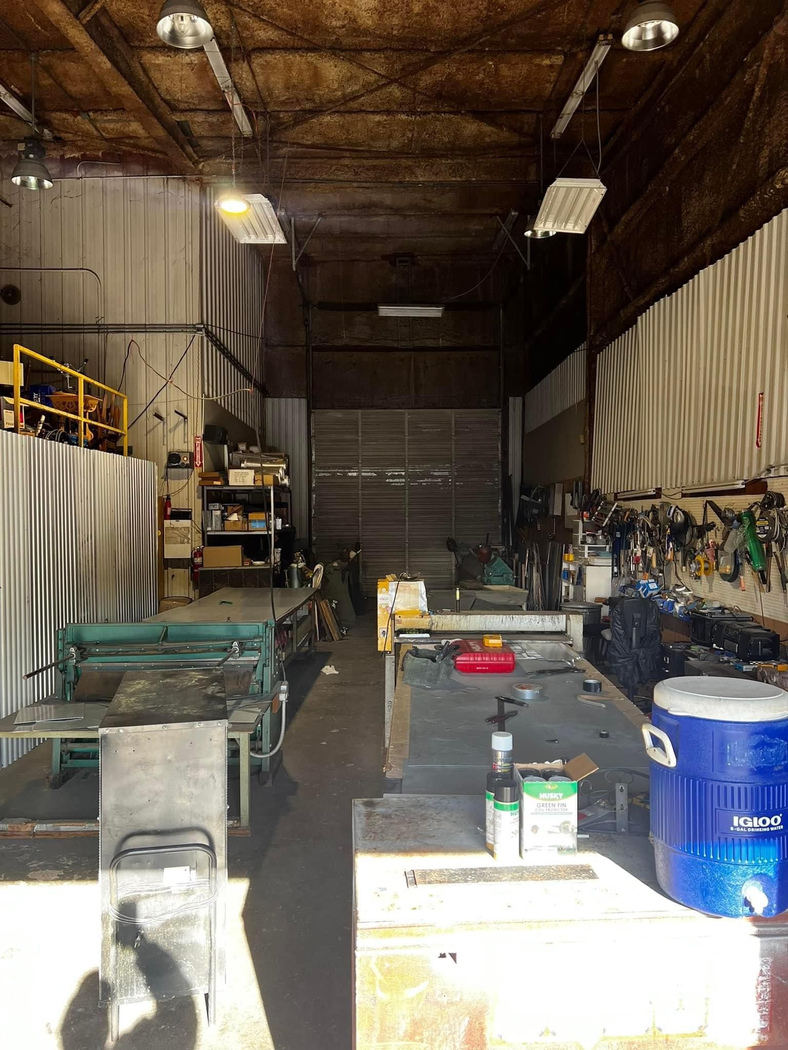 A large warehouse filled with lots of machinery and tools.
