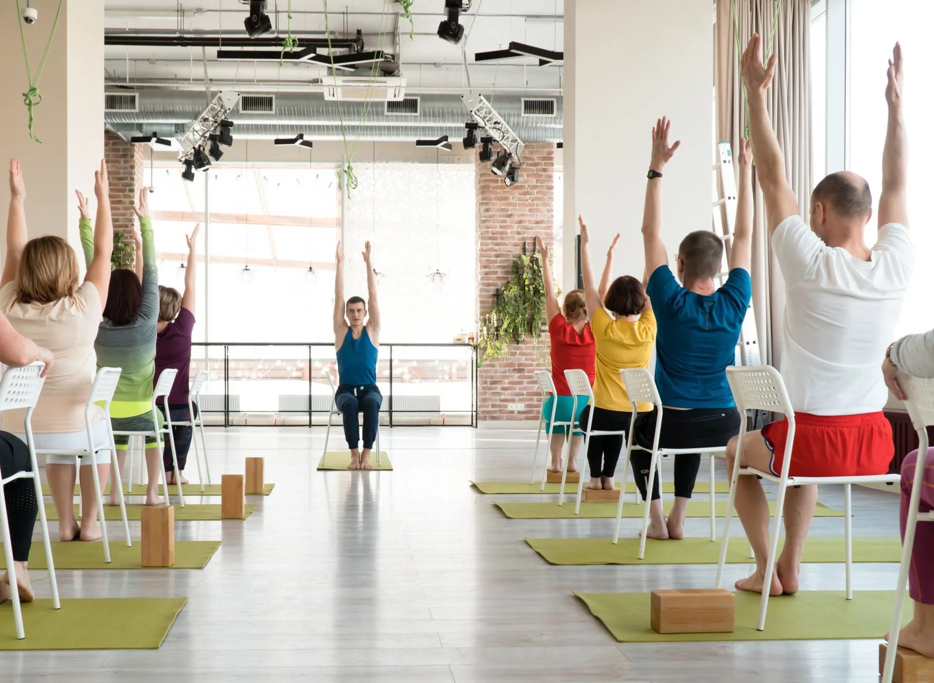 Chair yoga class for over-55s focusing on toning, balancing, stretching muscles, aligning bodies, and core strengthening while enjoying the experience
