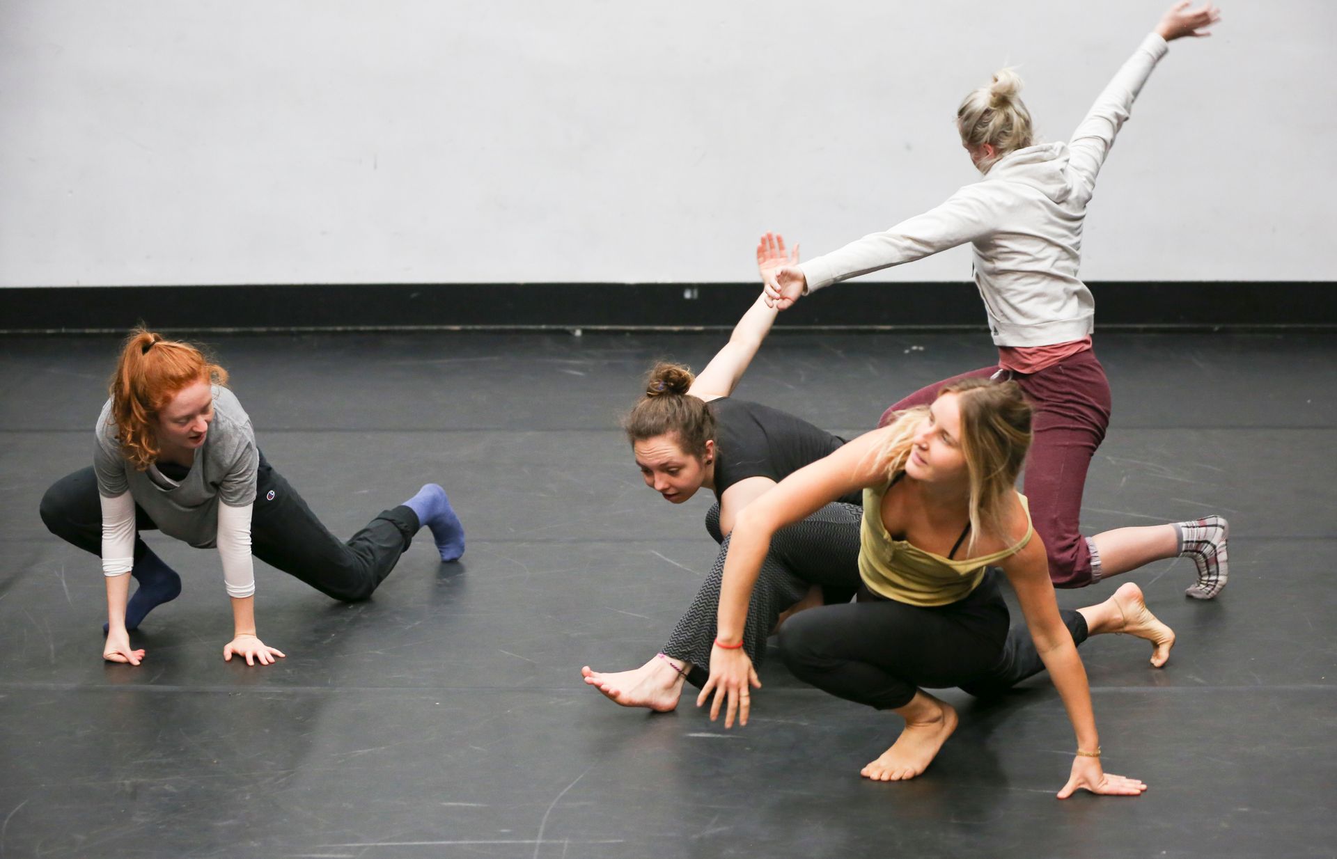 Contemporary dance class practicing fluid choreographic moves together