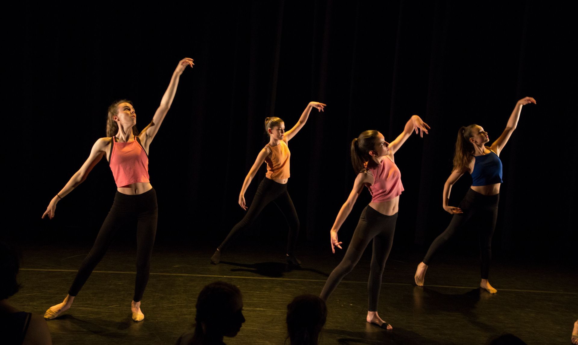 Elegant teenage dancers showcasing expressive contemporary choreography at public performance