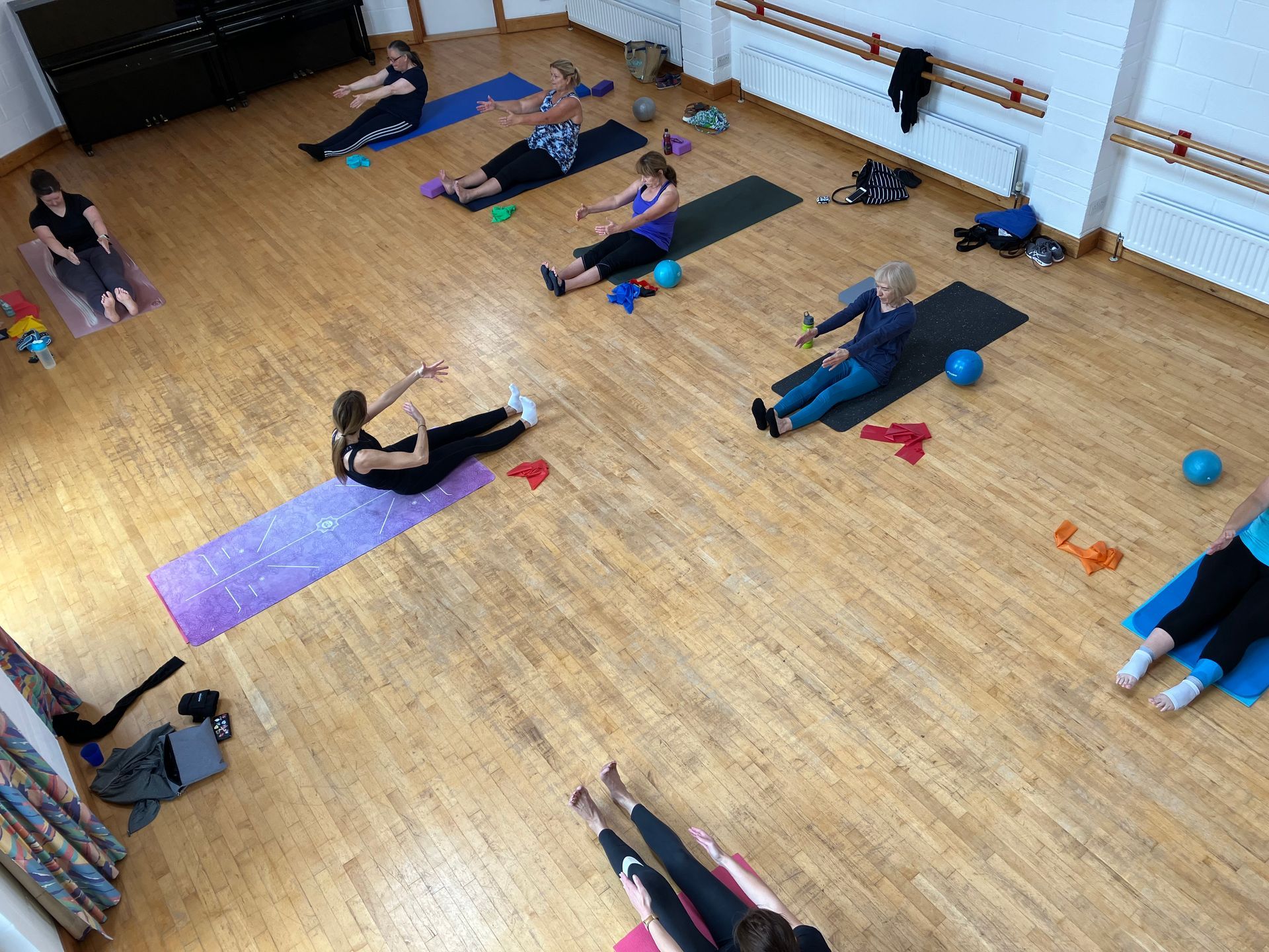 Group Mat Pilates class focusing on improving posture, strength, and well-being
