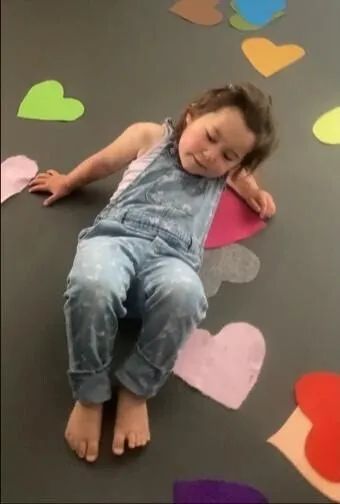 A toddler having fun working on her coordination in dance class