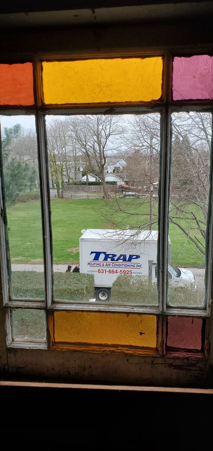 service truck outside of a home being viewed from an upstairs window