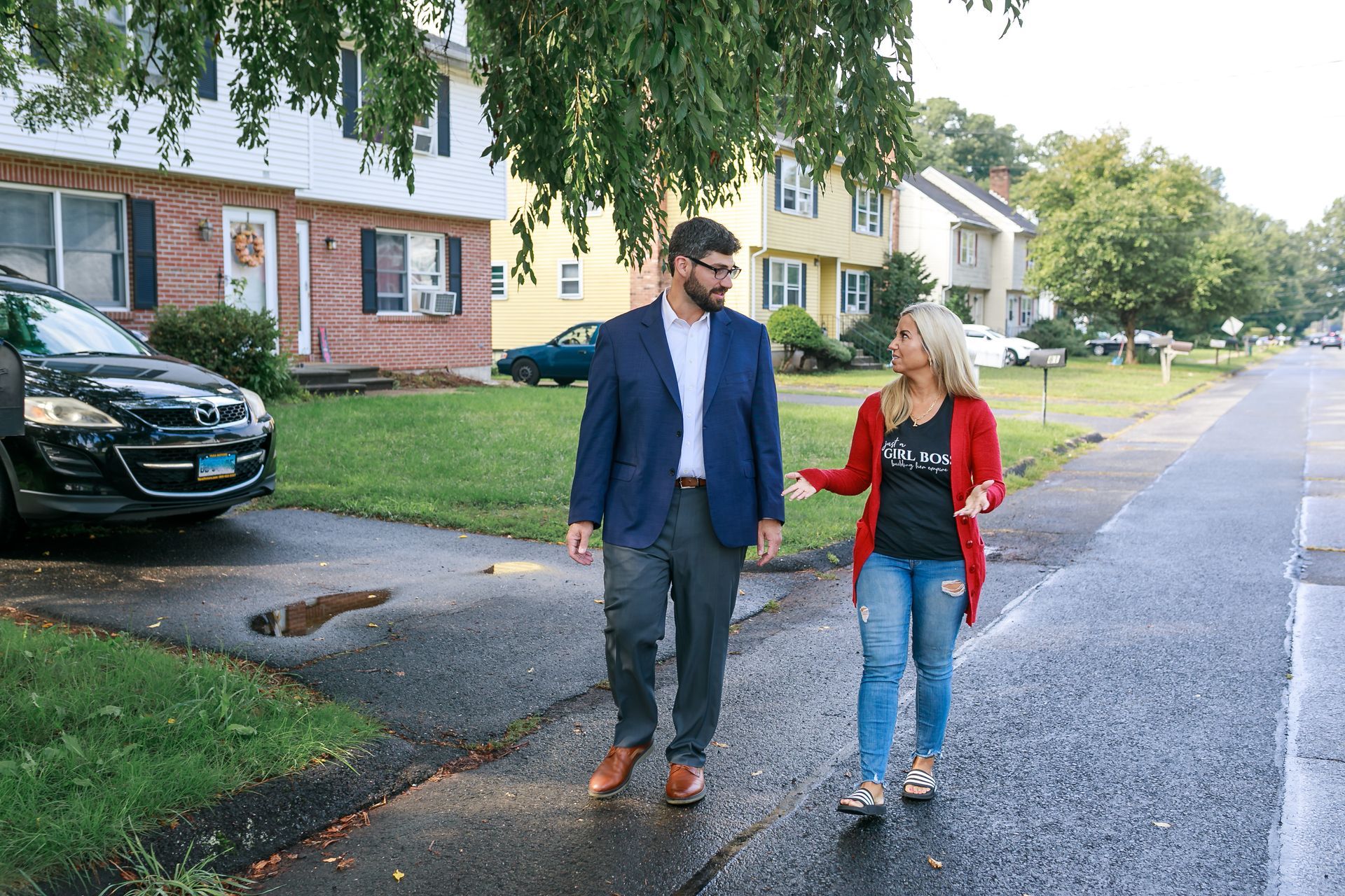 A Geoff Luxenberg and a constituent are walking down a sidewalk.
