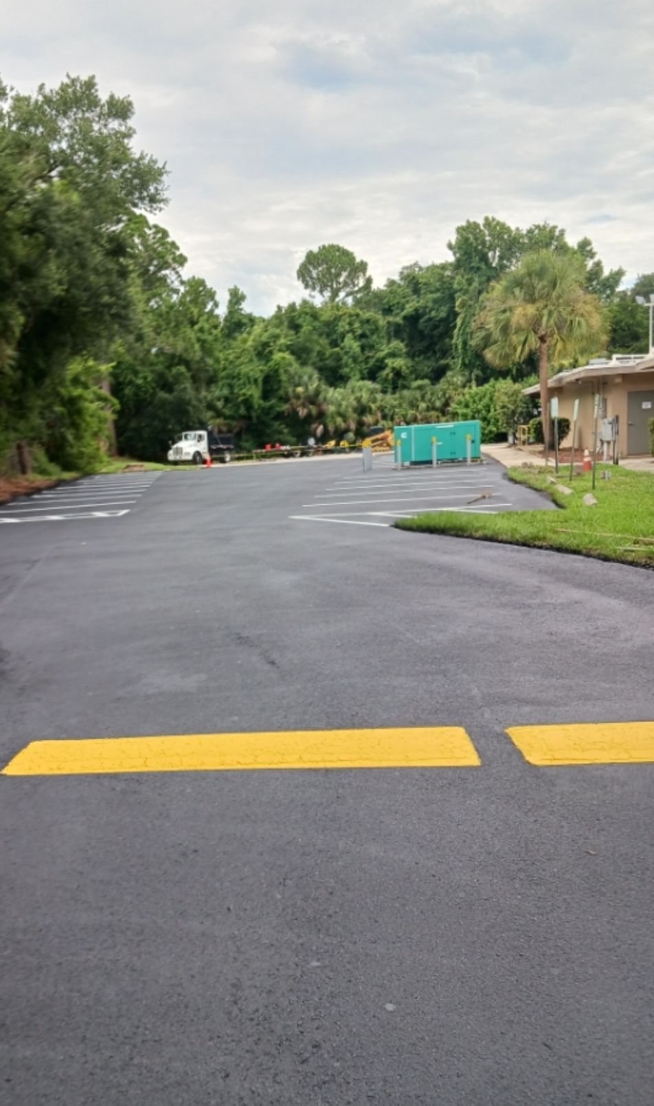 A parking lot with a yellow line on the side of it.